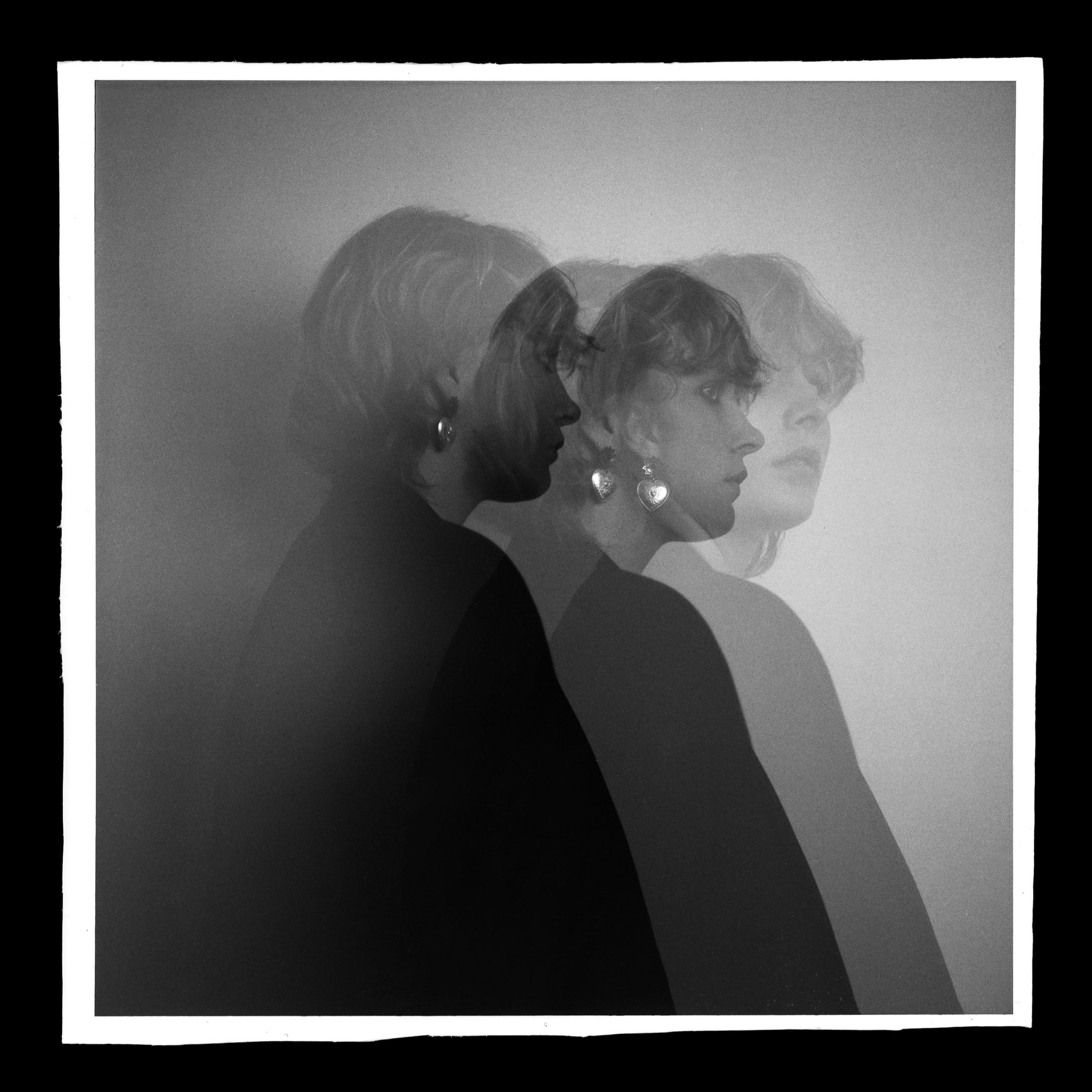 A multiple exposure image shows the same person overlaid on themselves, they are wearing a large earing